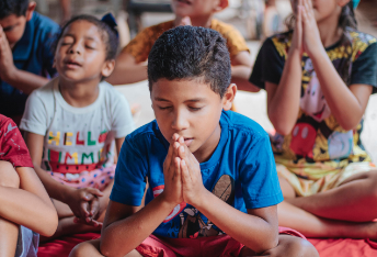 child praying in Sunday School